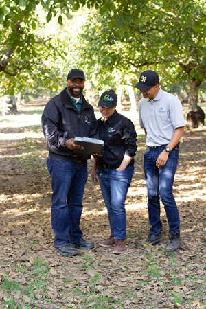 Smiling CDFA inspectors in an orchard