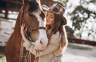 young happy woman with horse ranch