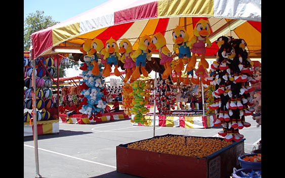 Plush prizes hang in a midway game booth