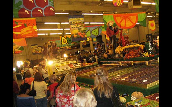 Fairgoers enjoy a colorful display of the county's bountiful harvest. Big Fresno Fair, Fresno