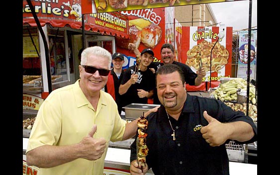 Huell Howser and "Chicken" Charlie Boghosian enjoy some delicious fair food. San Diego County Fair, Del Mar