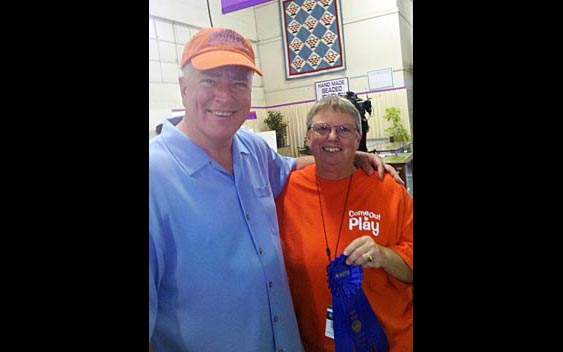 Huell Howser poses with one of the fair's prize winning quilters. Alameda County Fair, Pleasanton