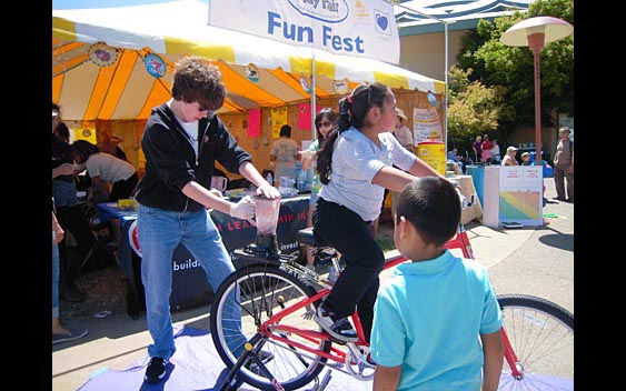 Fairgoers blend their own smoothies using a bicycle-powered blender - green never tasted so good! Marin County Fair & Exposition, San Rafael