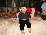 Child sitting on hay