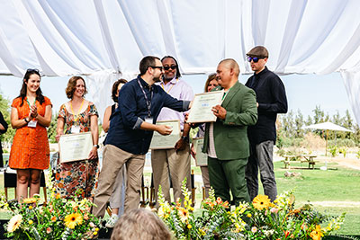 A plaque is awarded on stage