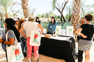 Attendees view an exhibit booth