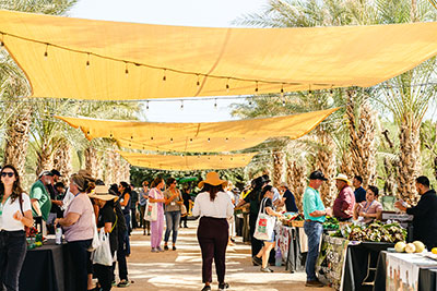 Outdoor promenade shaded by yellow awnings