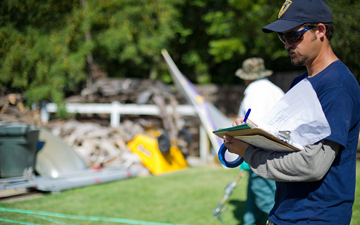 Crewperson taking notes on a clipboard